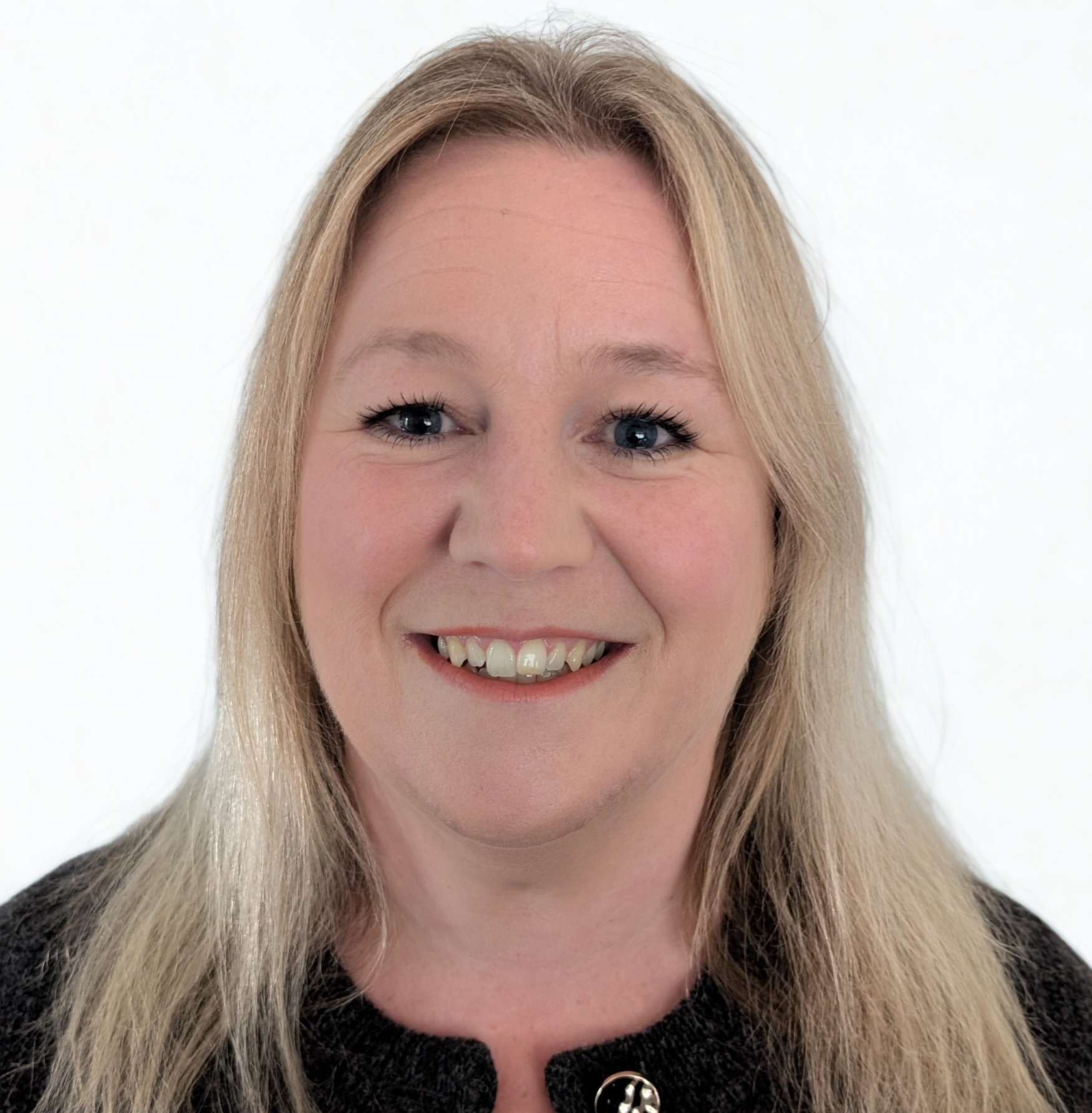 Portrait of a Sarah-Jane Madej, Finance Assistant, with long hair, wearing a black cardigan top, set against a plain grey background and framed in a circular shape.